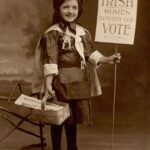 vintage photo of a suffragette girl holding a sign saying Irish Women demand the vote